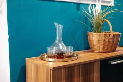 a tray with glasses and a vase on a table at Central Riverside 2BD Apt by Vltava & Theater in Prague