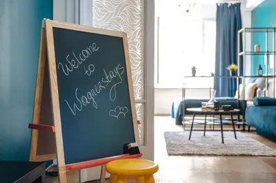 a chalkboard in a room with a living room at Central Riverside 2BD Apt by Vltava & Theater in Prague