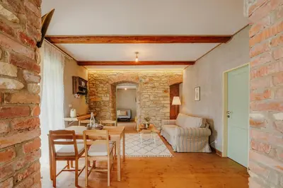 a living room with a brick wall and a table and chairs at Statek Pazderna