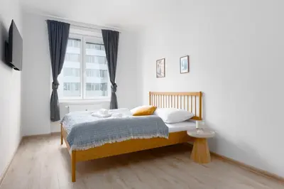a bedroom with a bed and a window at Apartment - 2 bedrooms, kitchen, close to metro in Prague