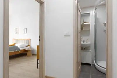 a bathroom with a shower and a sink and a bed at Apartment - 2 bedrooms, kitchen, close to metro in Prague