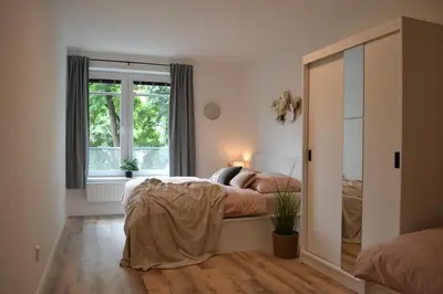 a bedroom with a bed and a window at Apartmán u Fontány 2-free parking in Poděbrady