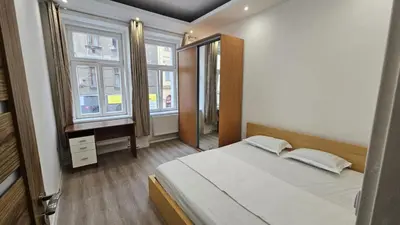 a bedroom with a large bed and a window at Relax Apartment in Prague