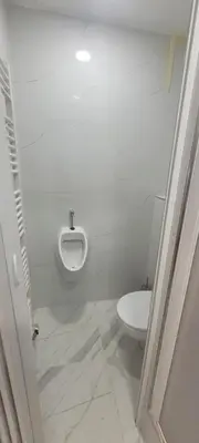 a bathroom with a white toilet and a urinal at Relax Apartment in Prague
