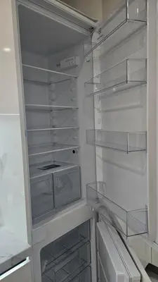 a white refrigerator with its door open with its shelves at Relax Apartment in Prague