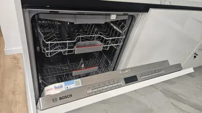 an empty dishwasher with its door open in a kitchen at Relax Apartment in Prague