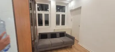 a gray couch in a room with a window at Relax Apartment in Prague