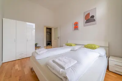 a bedroom with two beds with white sheets and yellow pillows at Historic Cozy Apartment with National Museum View in Prague