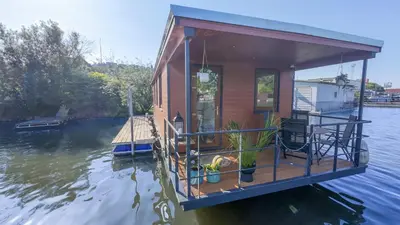 a house on a boat in the water at Houseboat Daisy in Prague