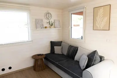 a living room with a couch and a window at Houseboat Daisy in Prague