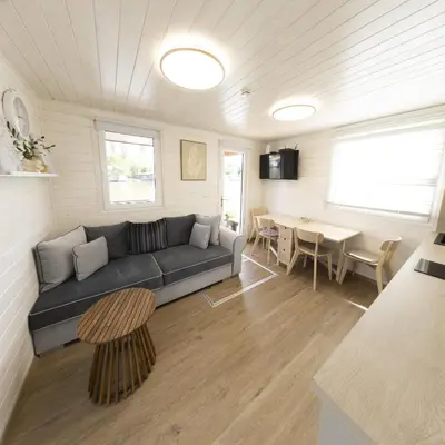 a living room with a couch and a table at Houseboat Daisy in Prague