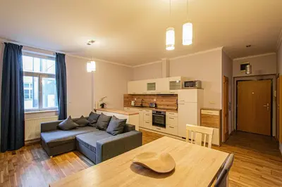 a living room with a couch and a table at Riverside Ruterra Apartment in Prague
