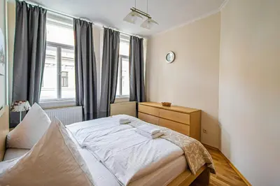 a bedroom with a large bed in front of a window at Riverside Ruterra Apartment in Prague