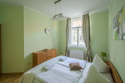 a bedroom with a large bed and a window at Riverside Ruterra Apartment in Prague