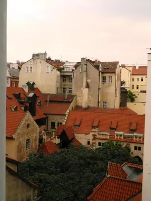 a group of buildings with red roofs at Riverside Ruterra Apartment in Prague