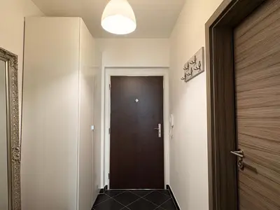 a hallway with a door and a black floor at UrbanFlat1615 with Parking in Prague