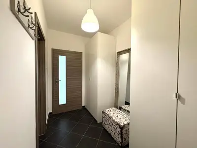 a hallway with a door and a stool in a room at UrbanFlat1615 with Parking in Prague