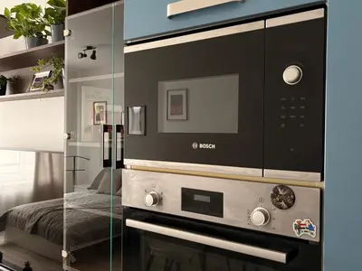 a kitchen with a microwave and a glass wall at UrbanFlat1615 with Parking in Prague