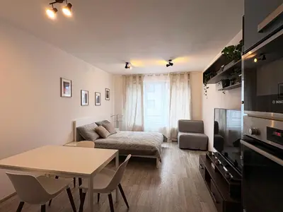 a living room with a couch and a table at UrbanFlat1615 with Parking in Prague