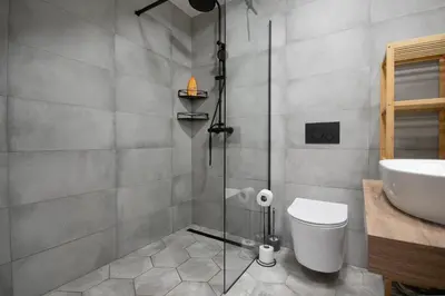a bathroom with a shower and a toilet and a sink at Atelier in the Heart of Karlín in Prague