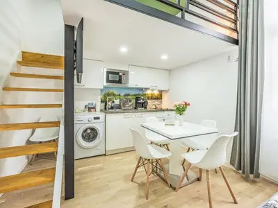 a kitchen and dining room with a table and chairs at Apartment Washington-3 by Interhome in Prague