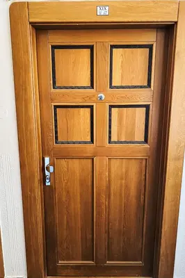 a wooden door in a room at Studio Art District Nook by Interhome in Prague