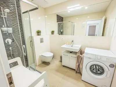a bathroom with a washing machine and a sink at Apartment Washington-2 by Interhome in Prague
