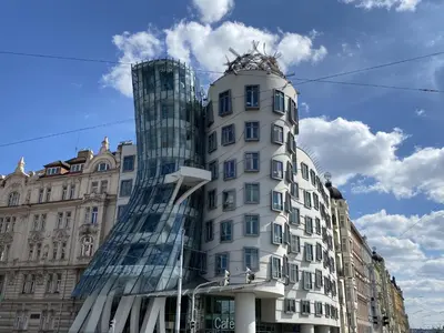 a tall white building with a glass building at Apartment Washington-2 by Interhome in Prague