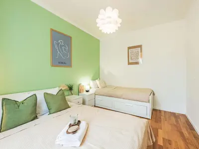 a small bedroom with a bed and a bed and a lamp at Apartment Čelakovsky-1 by Interhome in Prague