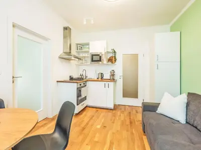 a kitchen and a living room with a couch and a table at Apartment Čelakovsky-1 by Interhome in Prague