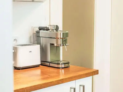 a mixer sitting on top of a wooden counter at Apartment Čelakovsky-1 by Interhome in Prague