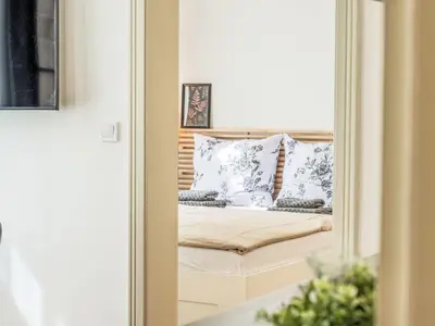 a mirror reflection of a bed in a room at Apartment Nekazanka by Interhome in Prague