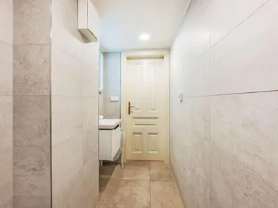 a bathroom with a white door and a sink at Apartment Nekazanka by Interhome in Prague