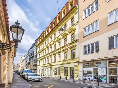 a street with buildings and cars parked on the street at Apartment Nekazanka by Interhome in Prague