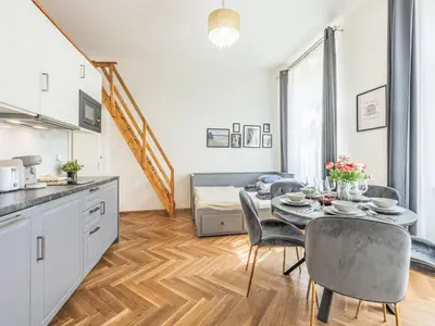 a kitchen and dining room with a table and chairs at Apartment Nekazanka by Interhome in Prague