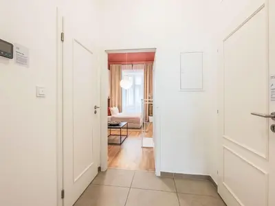 a hallway with white walls and a room with a door at Apartment Čelakovsky-2 by Interhome in Prague