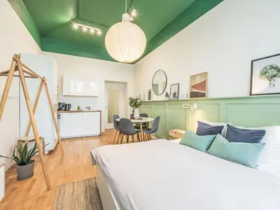a bedroom with a bed and a table with chairs at Apartment Čelakovsky-2 by Interhome in Prague