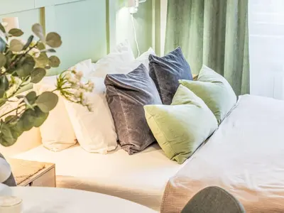 a bunch of pillows sitting on a bed at Apartment Čelakovsky-2 by Interhome in Prague