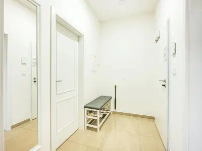 a room with a door and a bench in it at Apartment Washington-1 by Interhome in Prague