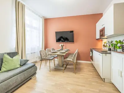 a kitchen and living room with a table and chairs at Apartment Washington-1 by Interhome in Prague