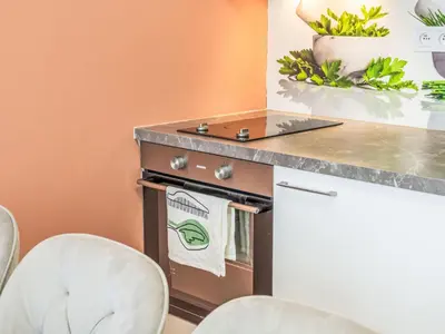 a kitchen with two chairs and a counter top at Apartment Washington-1 by Interhome in Prague