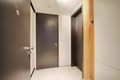 an empty corridor with a door in a room at Carme Apartment with Parking in Prague