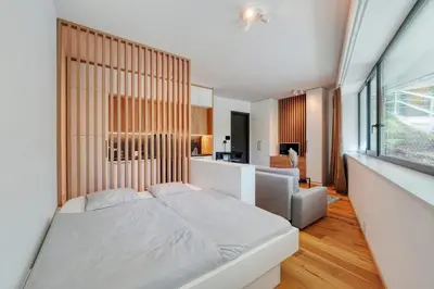 a bedroom with a white bed and a couch at Carme Apartment with Parking in Prague