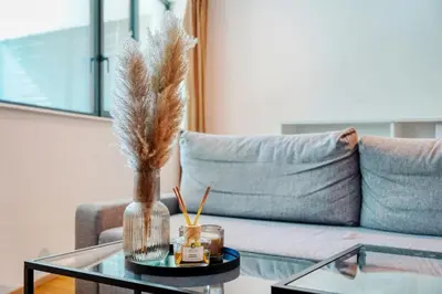 a living room with a couch and a glass table at Carme Apartment with Parking in Prague