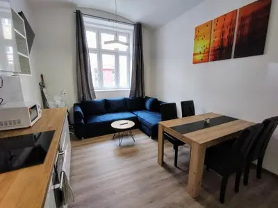 a living room with a blue couch and a table at Two bedroom apartment with parking in Prague