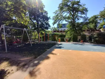 an empty playground with a swing at Two bedroom apartment with parking in Prague