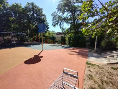 a park with a bench on a basketball court at Two bedroom apartment with parking in Prague