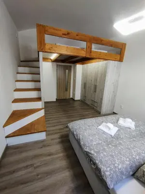 a bedroom with a bed and a staircase at Two bedroom apartment with parking in Prague