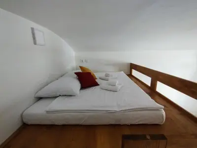 a bed in a room with a wooden floor at Two bedroom apartment with parking in Prague
