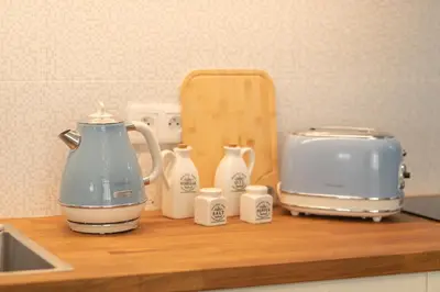 a kitchen counter with a tea kettle and a toaster at Tynska apartment in Prague